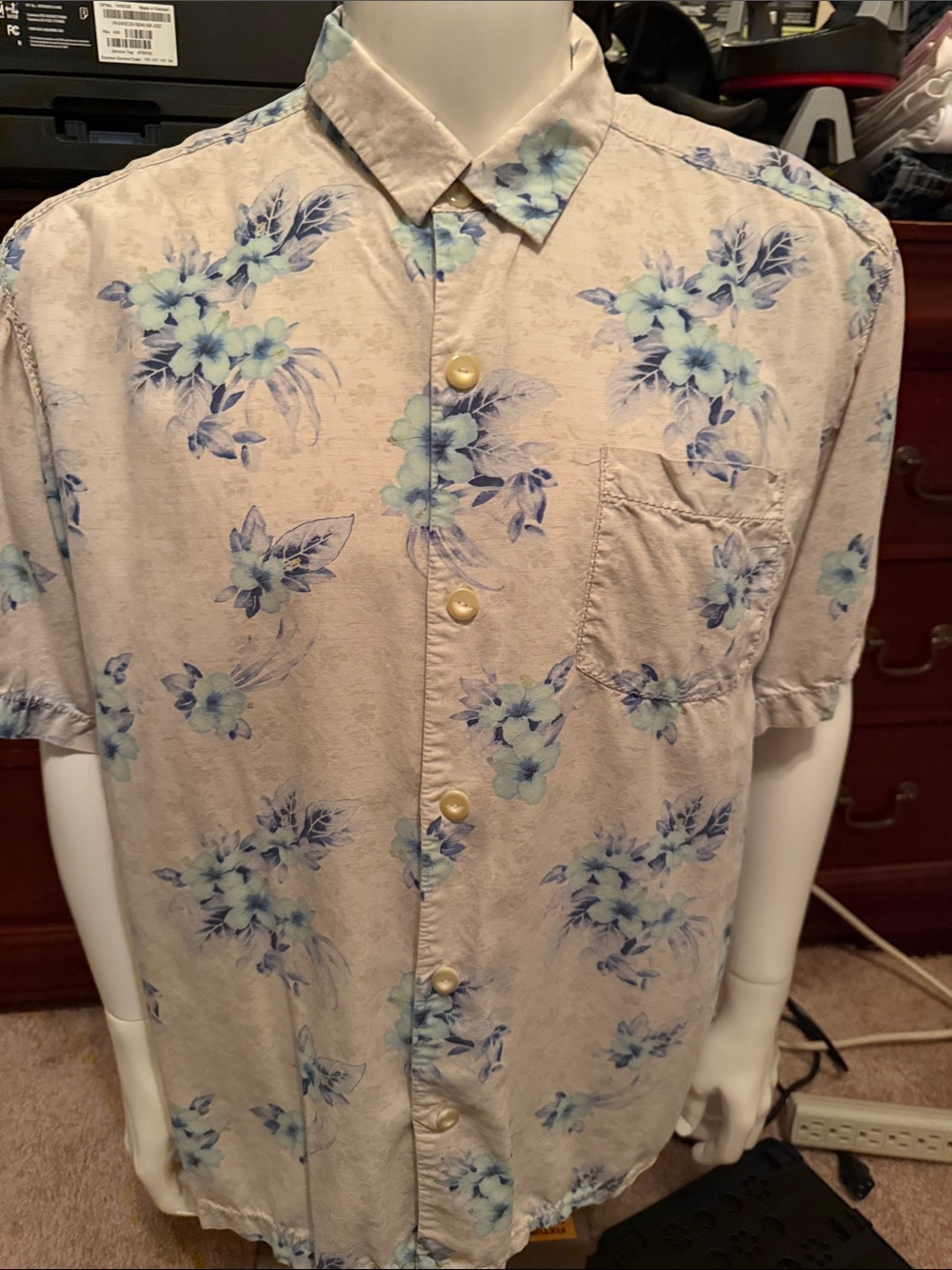 Tommy Bahama Beige Short-Sleeve Shirt with Blue Floral Print and front pocket.
